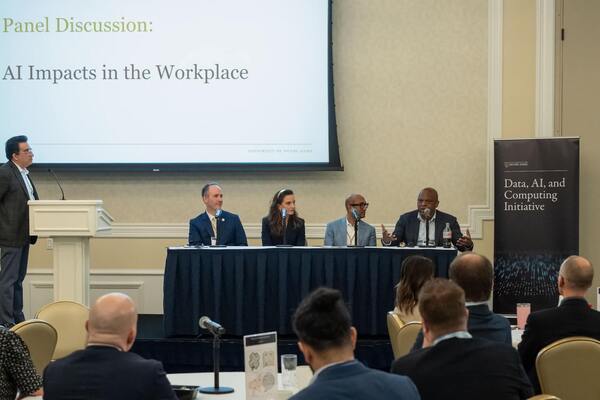 Four panelists and a speaker present at an "AI Impacts in the Workplace" discussion, with a Notre Dame Data, AI, and Computing Initiative banner.