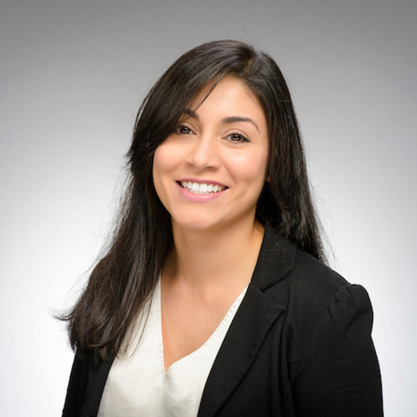Headshot of Jasmine Botello, a smiling woman with long dark hair and light brown eyes, wearing a black blazer and white top, looking directly forward.