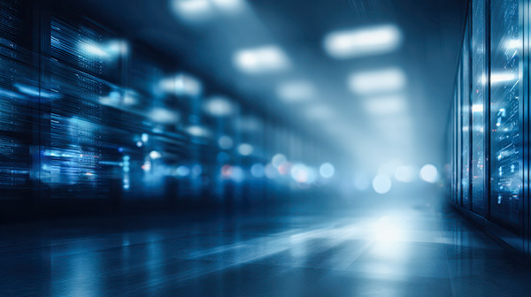 Long hallway in a data center, with rows of blinking blue server lights reflecting on the floor.