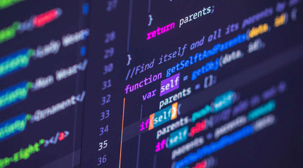 Programming code on a screen with multi-colored syntax highlighting on a dark background.