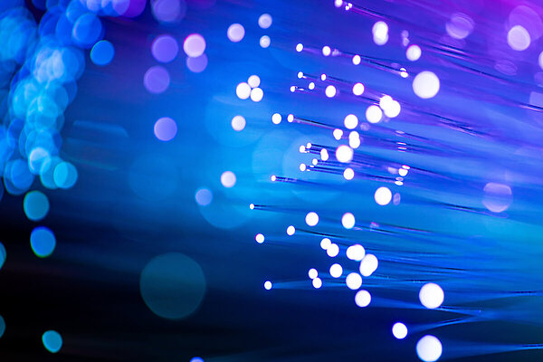 Close up of illuminated fiberoptic thread for illustrating AI.